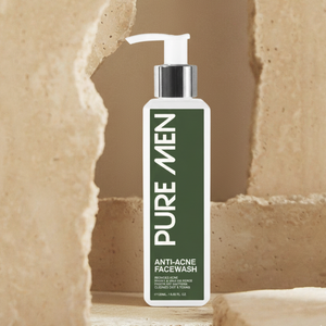 Bottle of Pure Men anti-acne facewash on a beige stone background