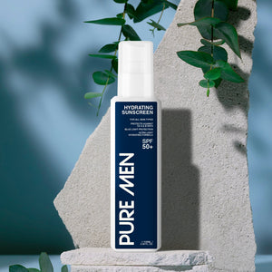 Bottle of Pure Men sunscreen on a stone surface with greenery