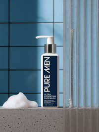 Pure Men Ultra Hydrating Facewash bottle with foam on a bathroom counter.