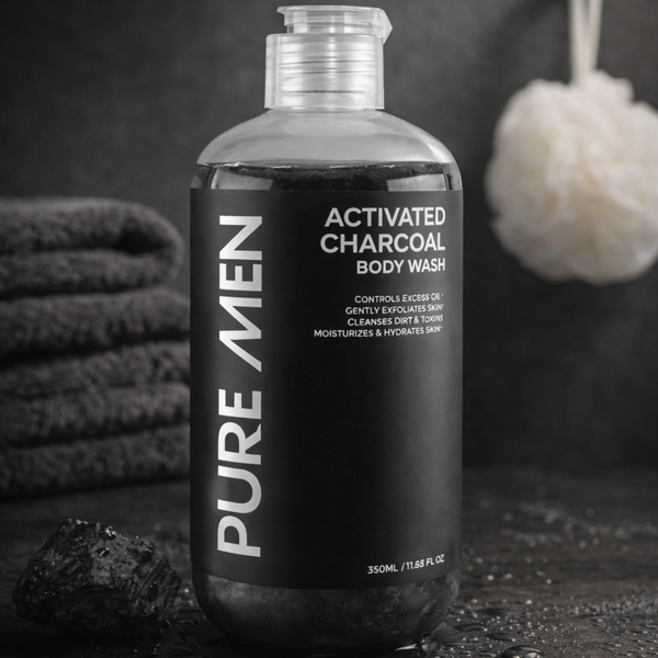 Bottle of Pure Men Activated Charcoal Body Wash with towels and a loofah in the background.